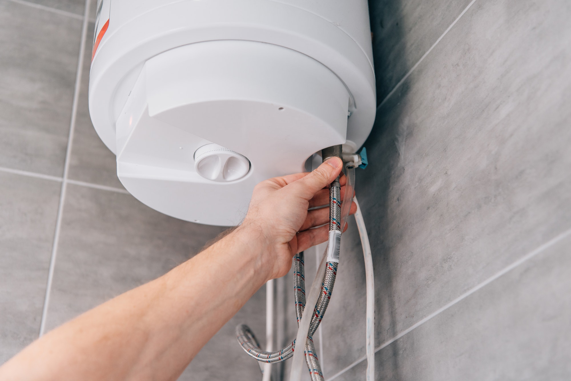 cropped-shot-of-male-plumber-repairing-electric-boiler-in-bathroom.jpg